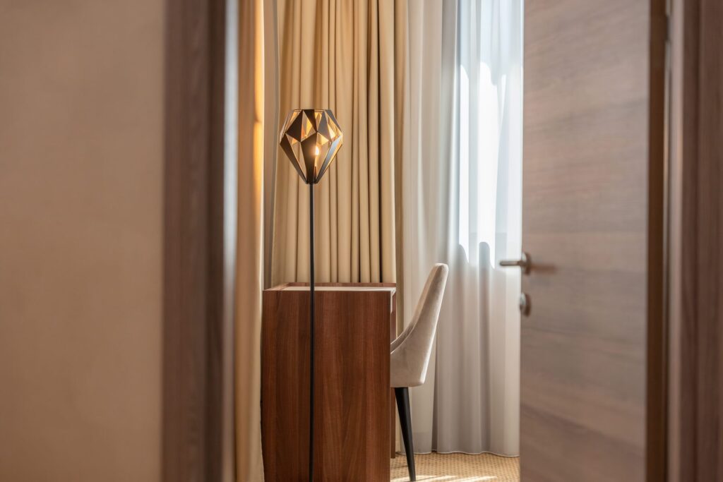 Hotel corridor with a floor lamp and an armchair